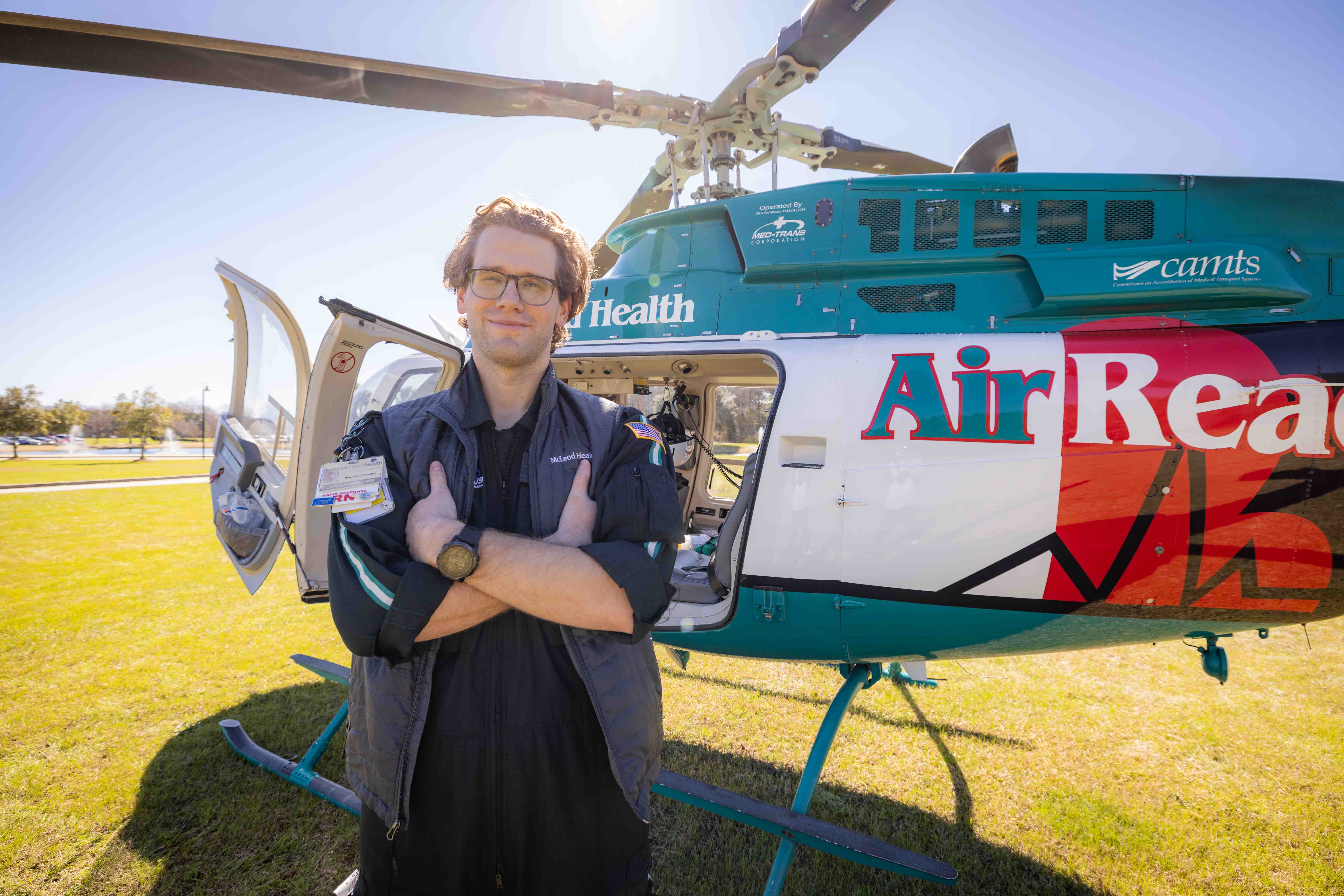 FDTC Alumni Chris Lutcken stands by an emergency transport helicopter that he flies in as a flight nurse.