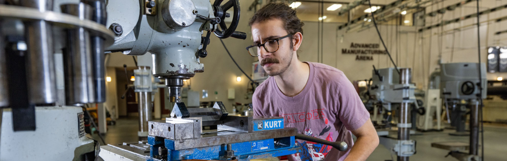 An FDTC student operates a CNC machine in the advanced manufacturing arena