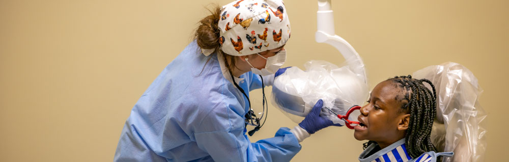 An expanded duty dental assisting student practices dental techniques in the dental hygiene lab