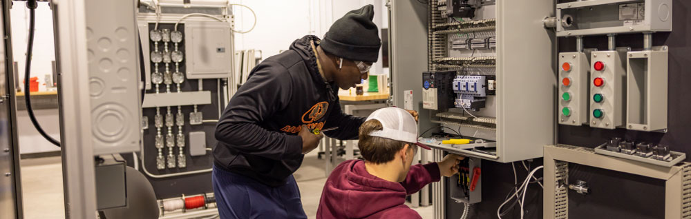 Electrician students at FDTC work on a electrical project