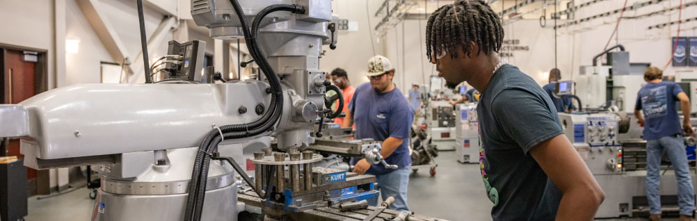 Machine Tool Technology students work on manufacturing machines