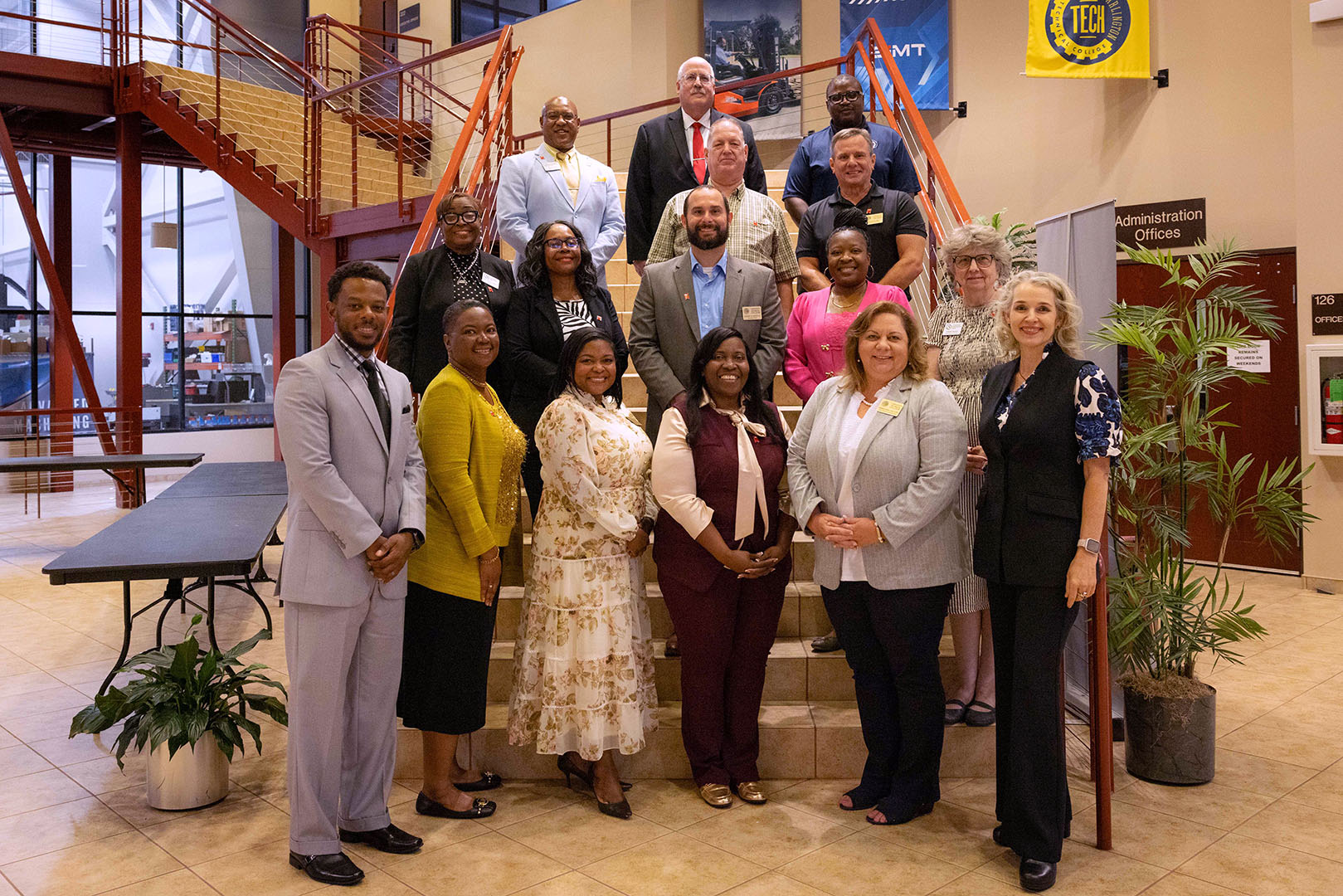The ACUE awarded faculty and staff are standing together on stairs posing for a group picture.