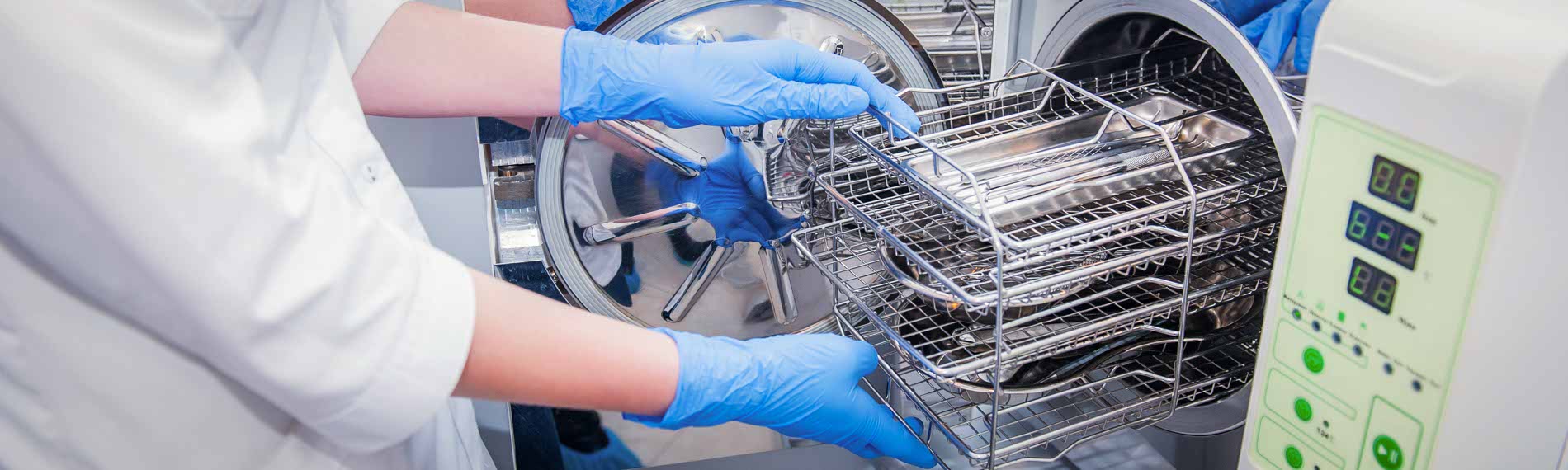 An employee sterilizing medical instruments.