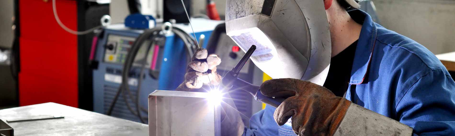 A welder using a TIG welder.