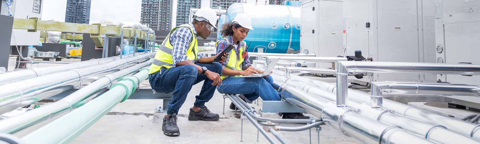 An apprentice and his master work on a job site
